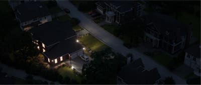 Houston-area neighborhood at night with a few homes still lit during a power outage